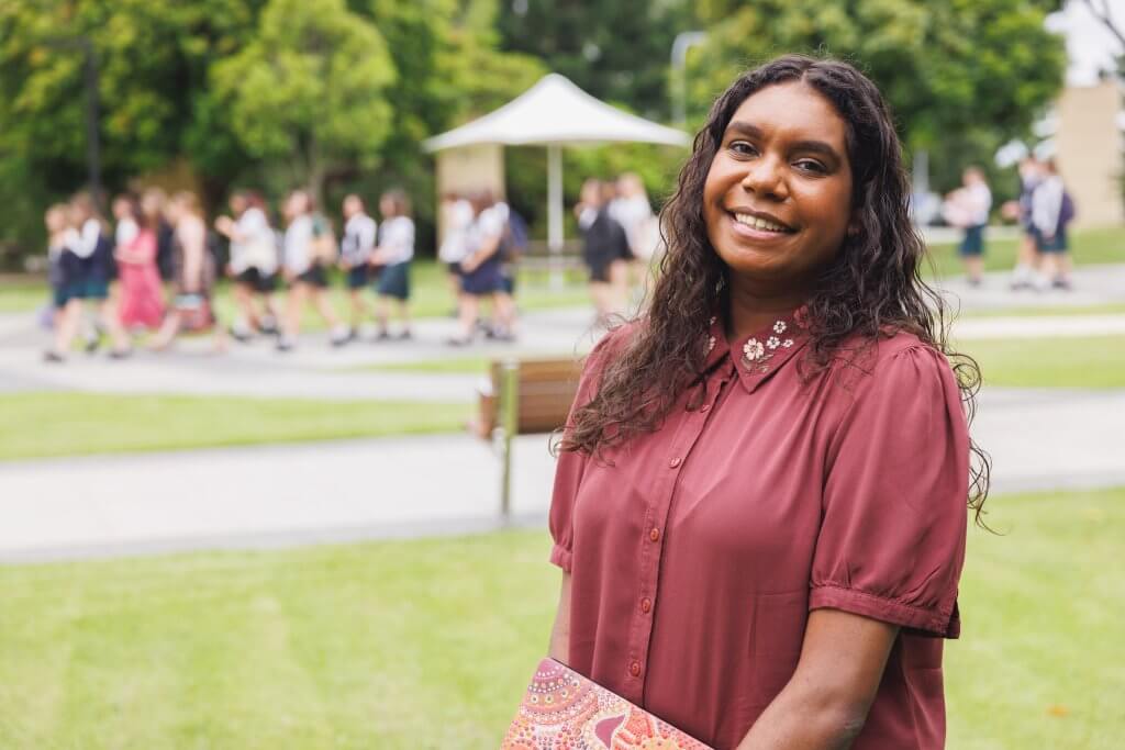 Female Aboriginal Australian Student Holding Laptop She Designed And Painted Herself